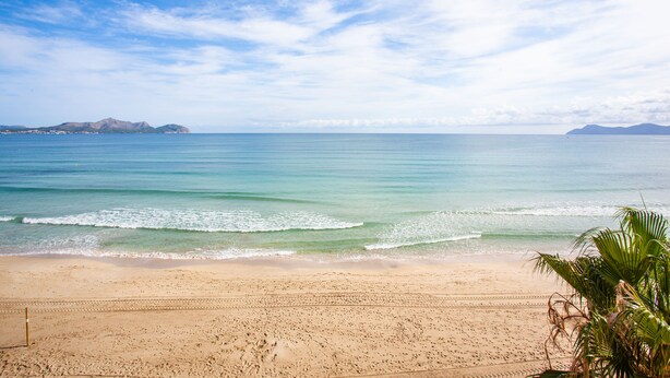 A beach with clear skies and calm waters.