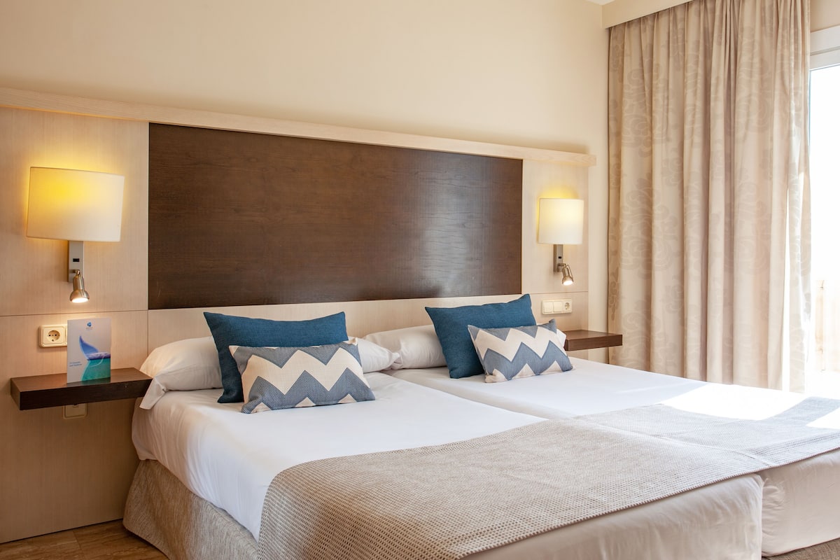Desk, blackout curtains, free cots/infant beds, free WiFi
