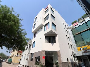 A multi-story building with a modern design, featuring a prominent entrance with glass doors and a sign indicating office space availability. - OYO 12754 Hotel The Best (New Delhi)