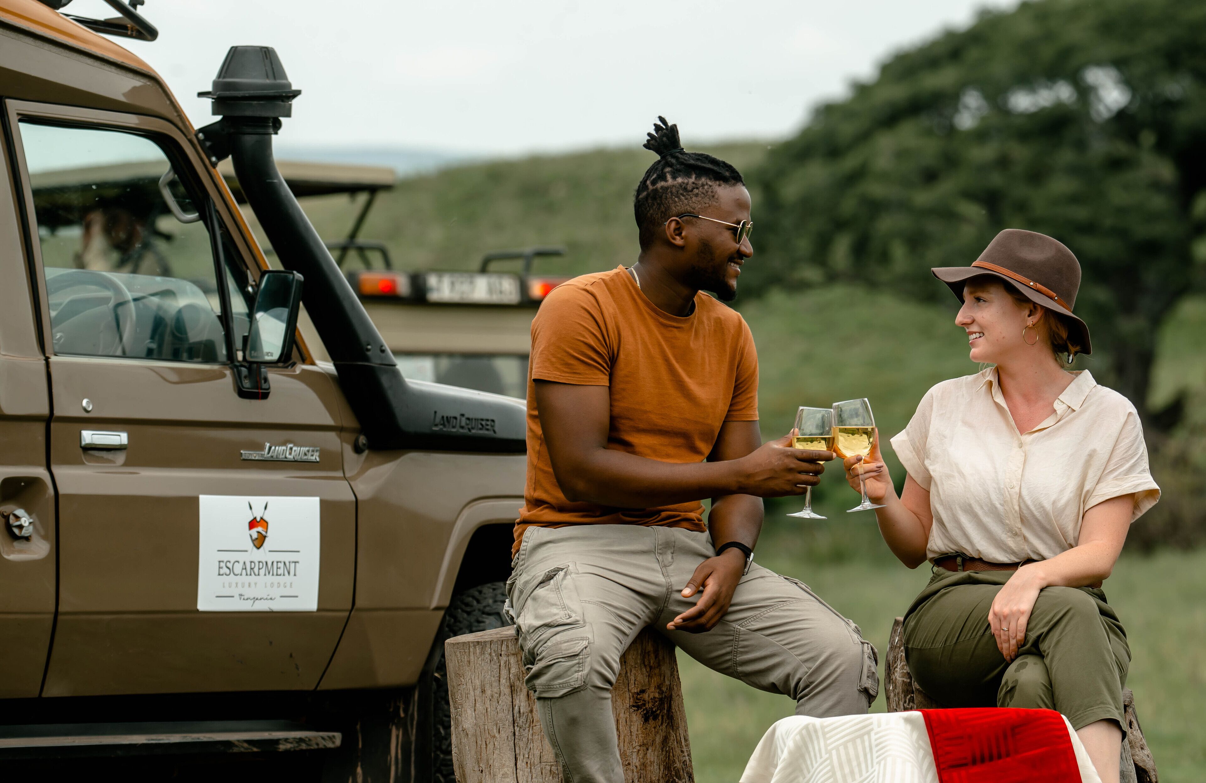 A Land Cruiser parked with a sign indicating a luxury lodge.