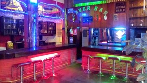 A bar area with neon lights, bar stools, and a sign reading "AFORE BAR". - Hotel Daylu (Punchana)
