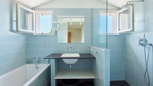A bathroom with a bathtub, sink, and shower. - House / Villa - ARBONNE (Arbonne)