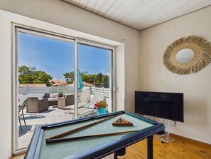 A pool table with a view of an outdoor patio area. - House for 6 - garden and terrace - 300m beach (Bretignolles-sur-Mer)