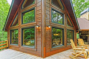 A cabin with large windows, a deck, and wooden furniture. - Serenity on The Mountain | Blue Ridge, GA (Blue Ridge)