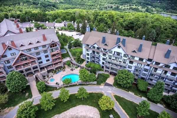 - Aerial view of resort with pool, paths, and lush greenery - Convenient location near trails and scenic mountain spots - Perfect for families and groups enjoying an outdoor escape
