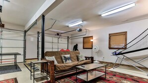 A living room with a sofa, coffee table, and patterned rugs.