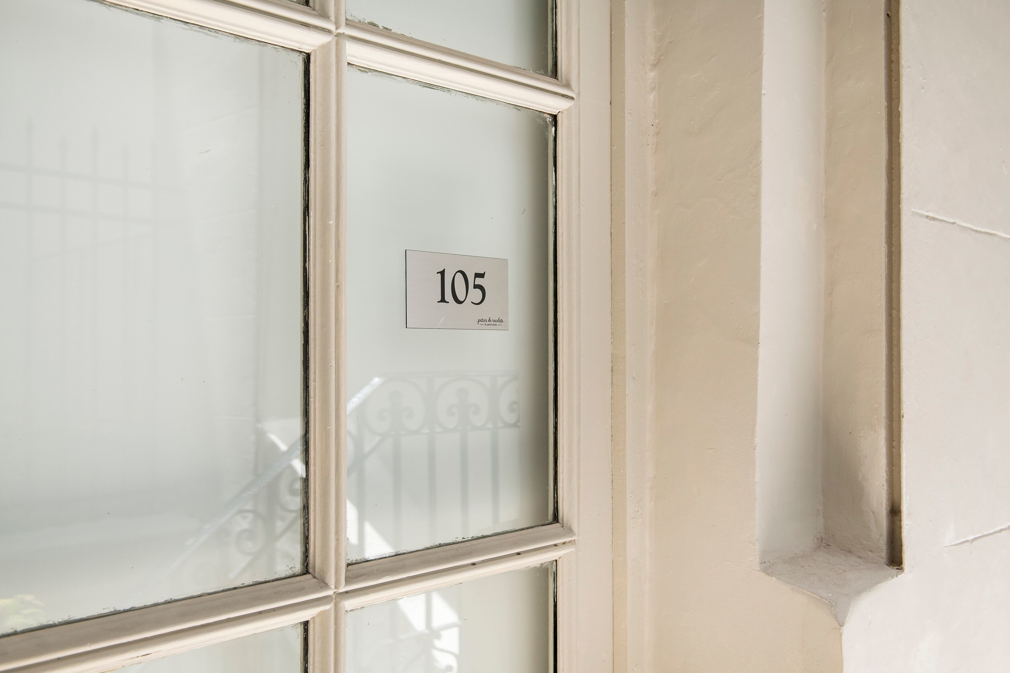 A window with a number "105" and a small sign below it.