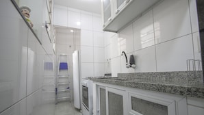 A kitchen with white cabinets, a granite countertop, and a stainless steel range hood. - LineRio Copacabana Residence 189 (Rio de Janeiro)