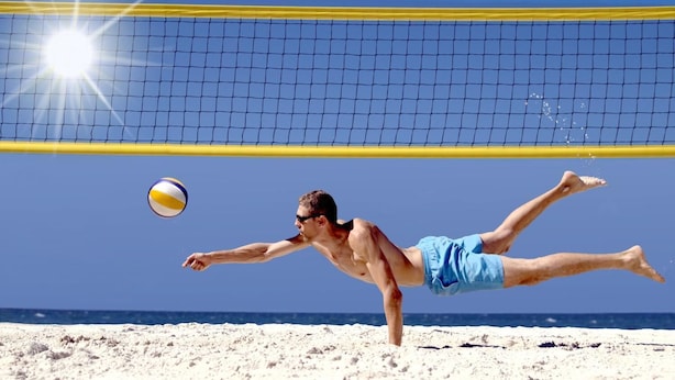 A beach volleyball player diving to hit the ball. - LineRio Copacabana Residence 189 (Rio de Janeiro)
