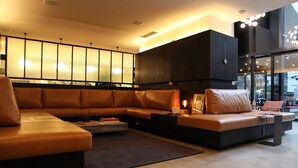 A modern living room with a sectional sofa, a coffee table, and a large window overlooking the city. - VN Bela Cintra (Sao Paulo)