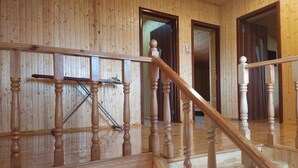A wooden staircase with a handrail and a wooden floor. - Kriyus (Gabala)