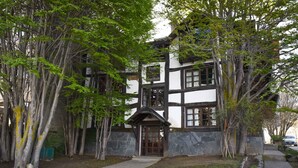 A traditional building with a stone facade, a wooden door, and a small porch.