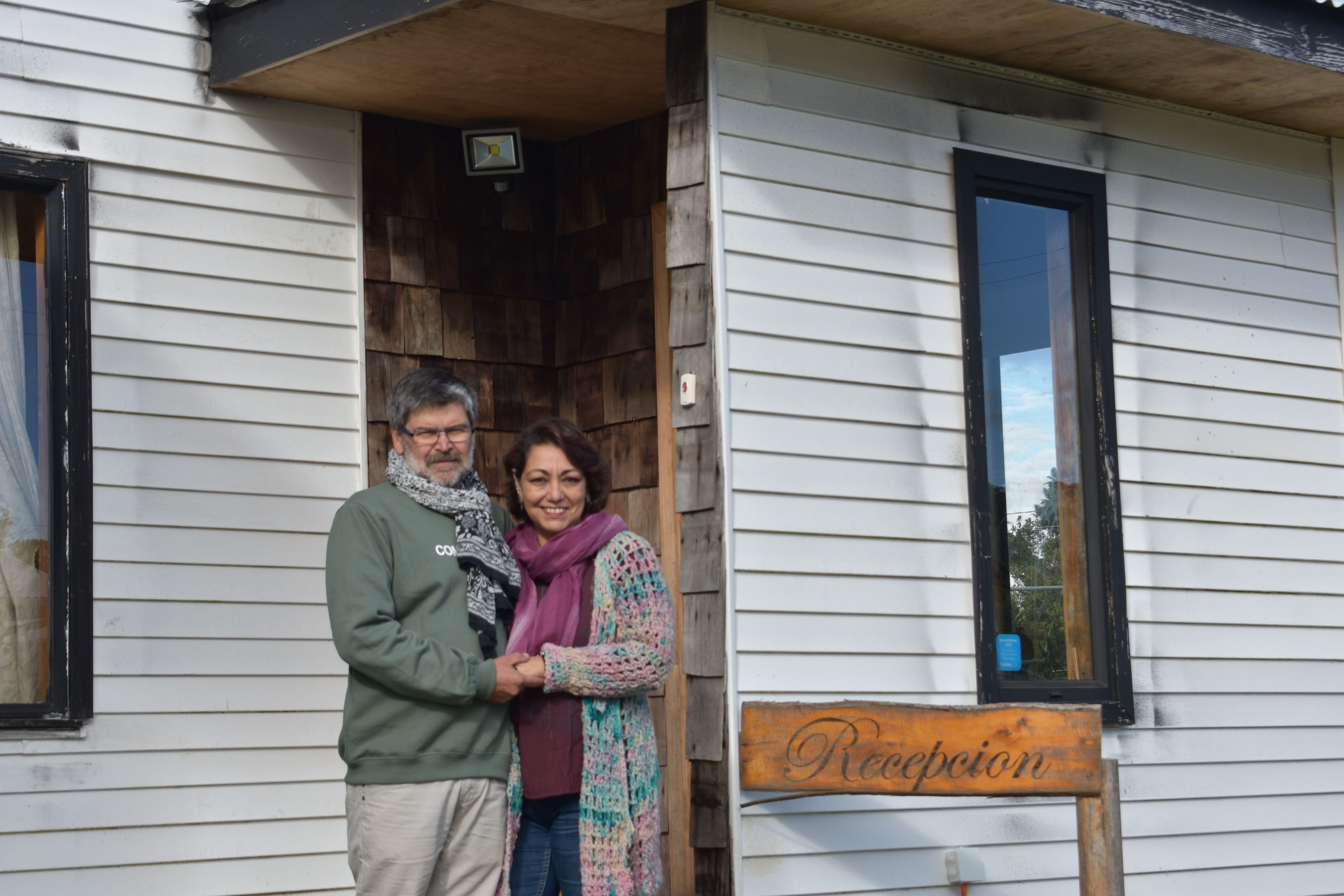A wooden house with a sign reading "Reception".