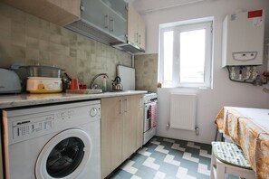 Apartment, Garden View | Private kitchen | Full-size fridge, oven, stovetop, coffee/tea maker