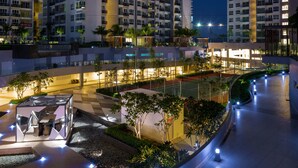 A modern hotel complex with multiple high-rise buildings, outdoor seating areas, and well-lit pathways. - Queens Suite by D Imperio Homestay (George Town)
