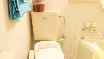 A small bathroom with a toilet, a bathtub, and a sink.