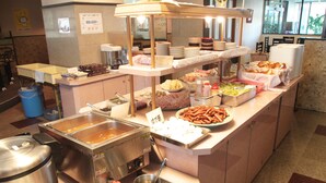 A buffet setup with various food items and cooking equipment. - Hikone Station Hotel (Hikone)