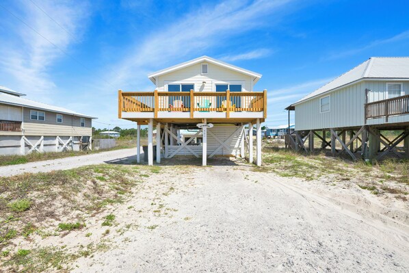 A beachfront house with a wooden deck and a covered porch. - Gulf Views | Pet Friendly | Steps to Beach Access (Gulf Shores)