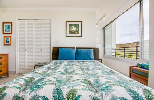 A bedroom with a bed, a nightstand, a dresser, a closet, and a window with a view. - 〰Waikiki〰Studio w/Spectacular Views & Balcony-WAIKIKI GRAND HOTEL® 712 (Honolulu)