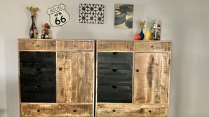 A wooden cabinet with two doors, each featuring a different wood finish.