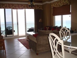 Relax in style with a comfortable sofa set and dining area offering ocean views.