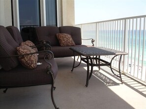 Relax on the balcony with a sofa and table, taking in the views of the water and shoreline.