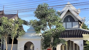 A traditional temple with a white facade, a central dome, and a bell tower. - Phu View Hideaway (Kantharalak)
