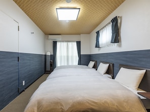 A hotel room with a large bed, a wardrobe, a mirror, and a window with curtains. - Tabist Kyogura Kyoto Nijo (Kyoto)