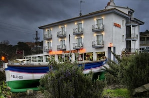 Un edificio con un restaurante llamado "Bona Vista Bar" y un barco amarrado en la parte delantera.