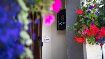 A door with a 'POST' sign and a 'NO SMOKING' sign.