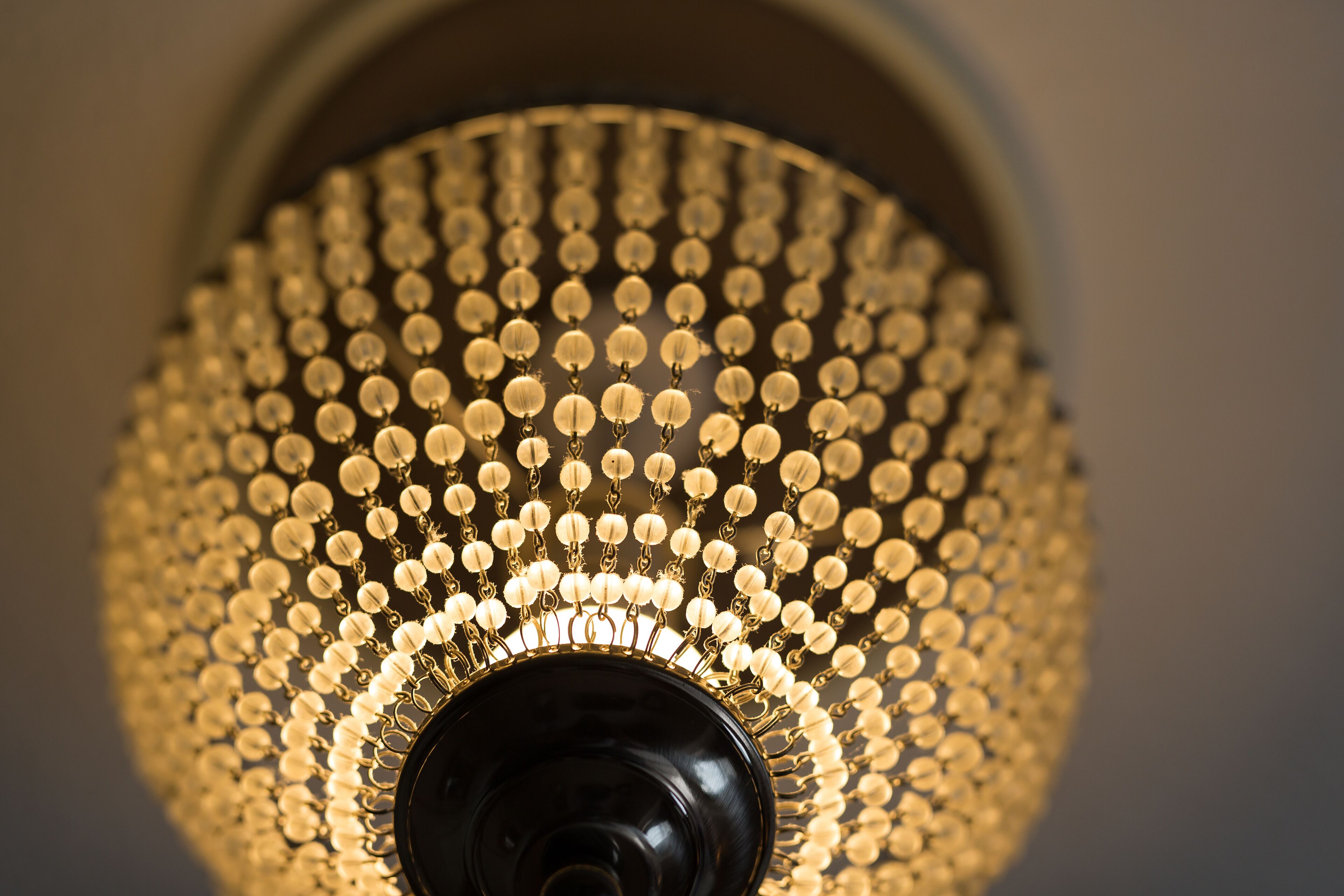 A close-up of a chandelier with multiple spherical elements and a central dark fixture.