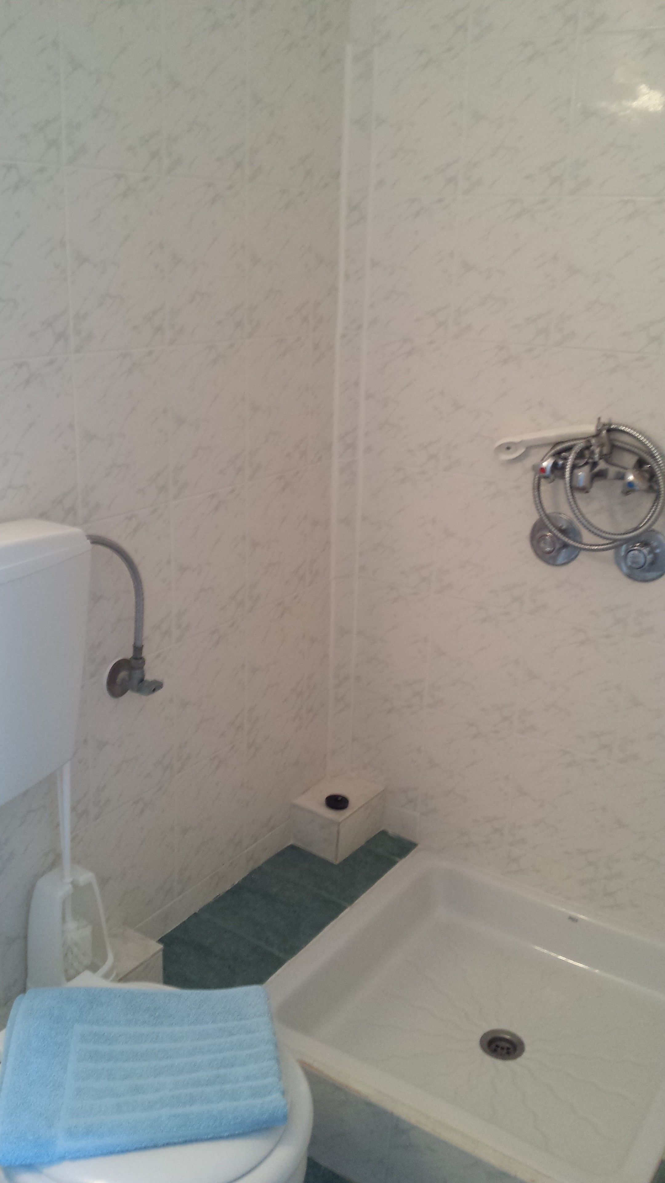 A bathroom with a toilet, a shower, and a bathtub.