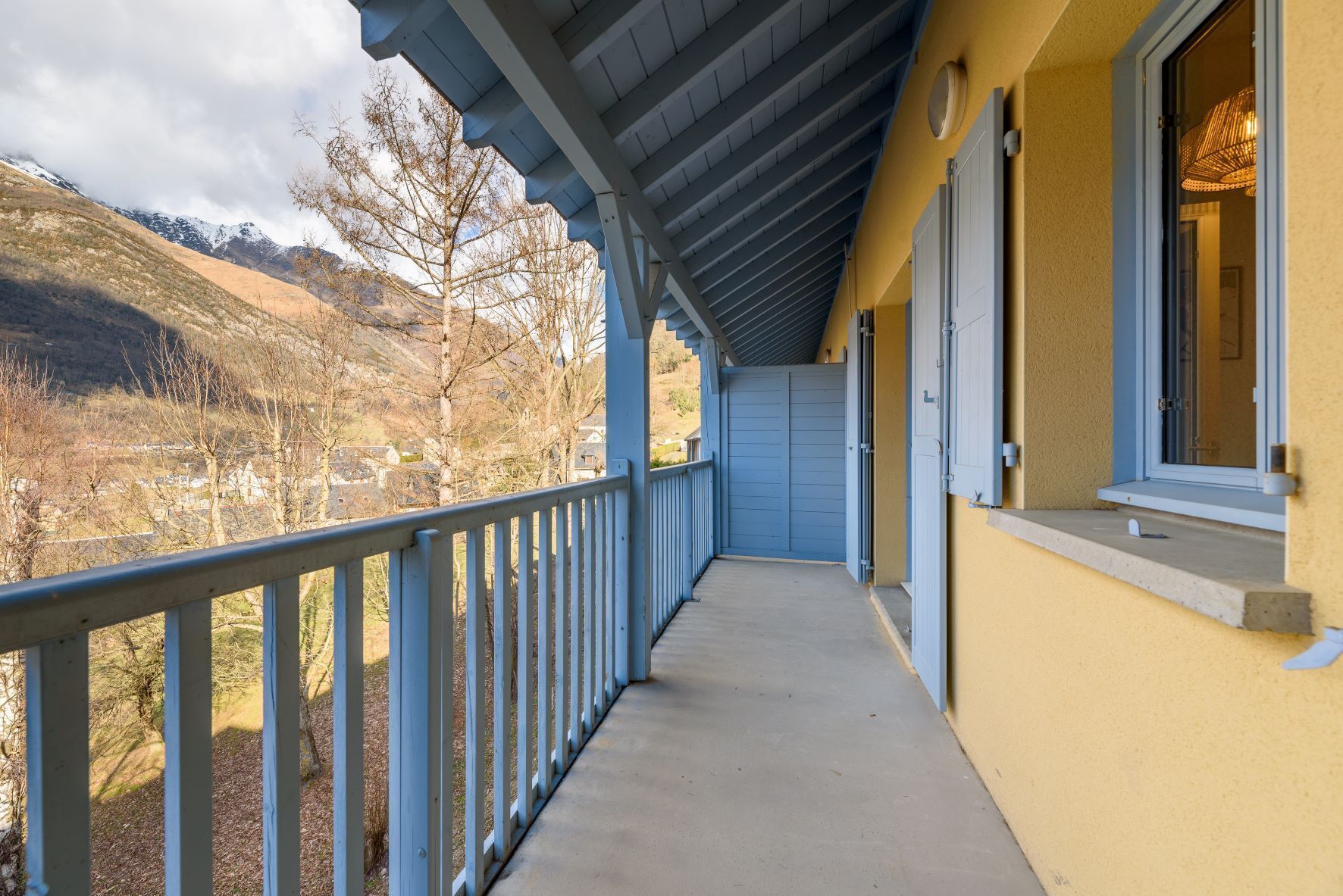 A balcony with a view of a mountainous landscape.