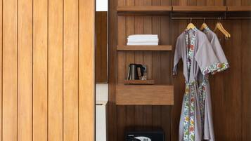 A wooden wardrobe with shelves, a hanging space, and a built-in radio.
