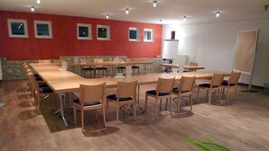 A conference room with a long table, multiple chairs, and a whiteboard. - Landhotel Schloss Sörgenloch (Sörgenloch)