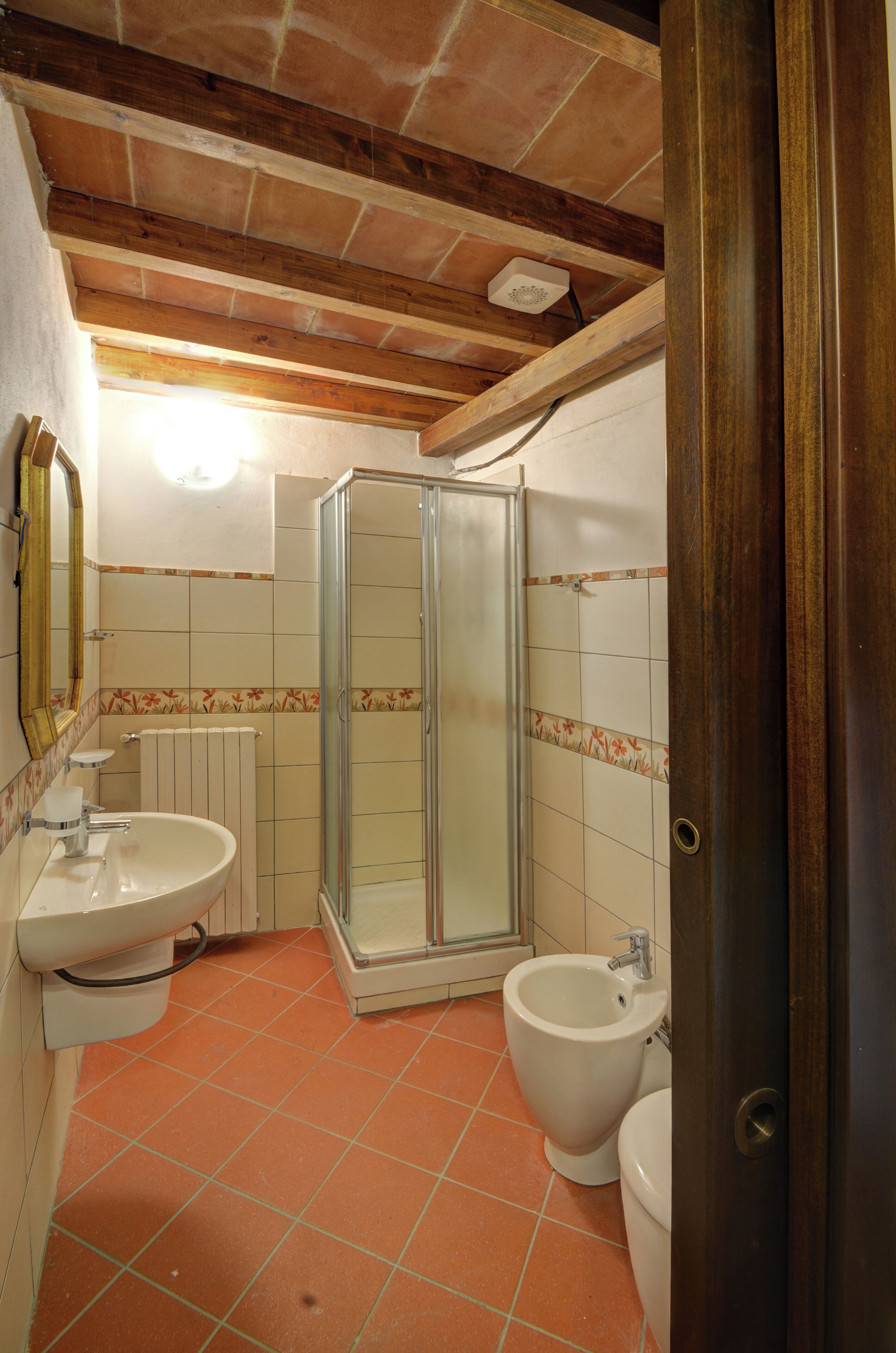 A bathroom with a shower, toilet, and sink.