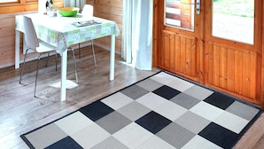 A wooden cabin interior with a dining area, a television, and a view of the outdoors. - Ásgeirsstaðir Cottages (Eidar)