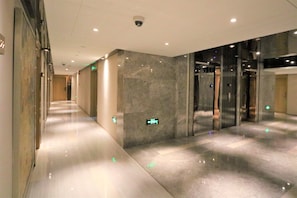 Stylish hotel corridor with polished floors and minimalist design.
