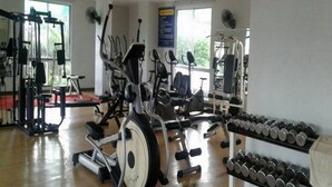 A gym with various exercise equipment, including treadmills, stationary bikes, and weight machines. - The Dlife (Hat Yai)