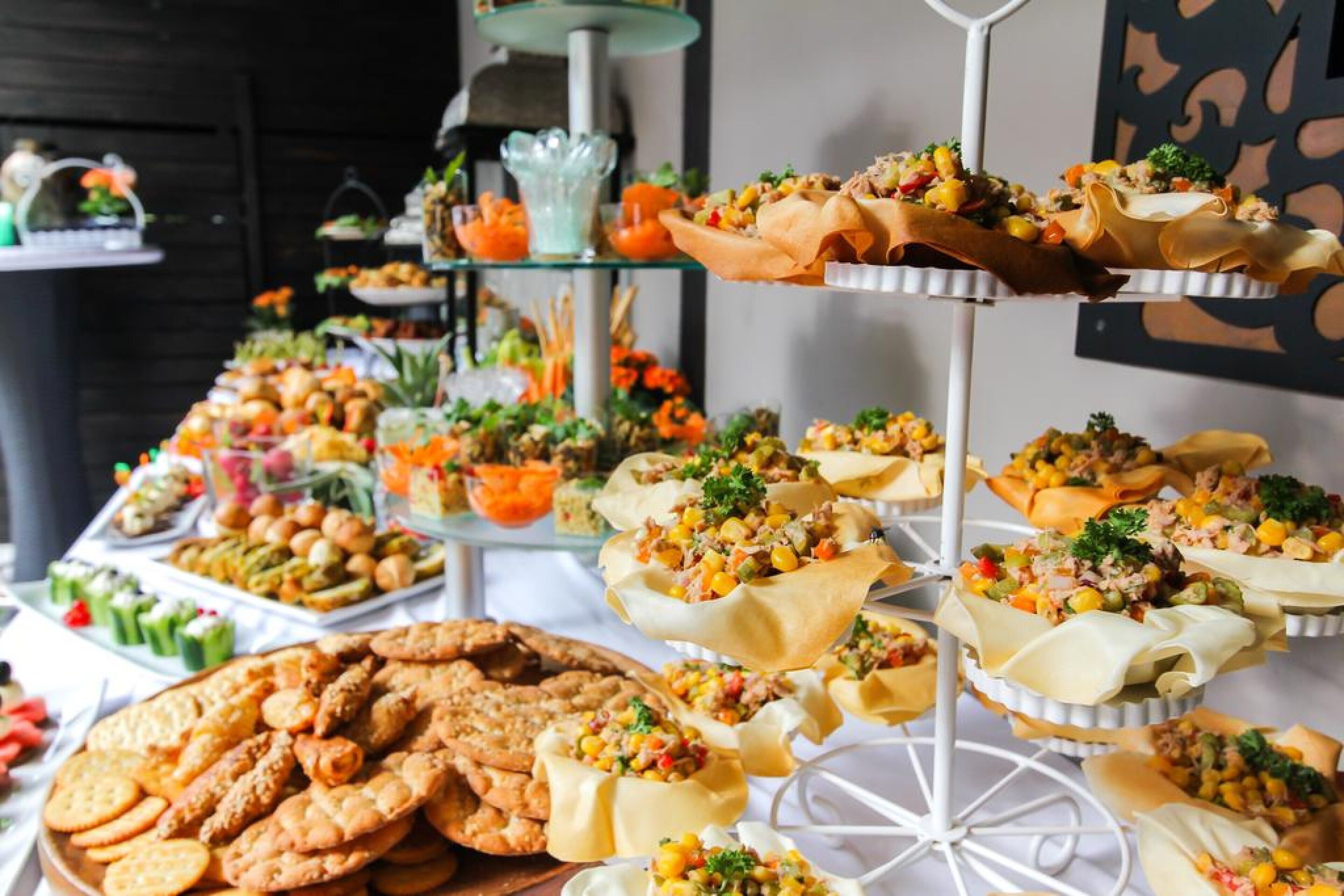 A buffet with various food items including appetizers, sandwiches, and snacks.