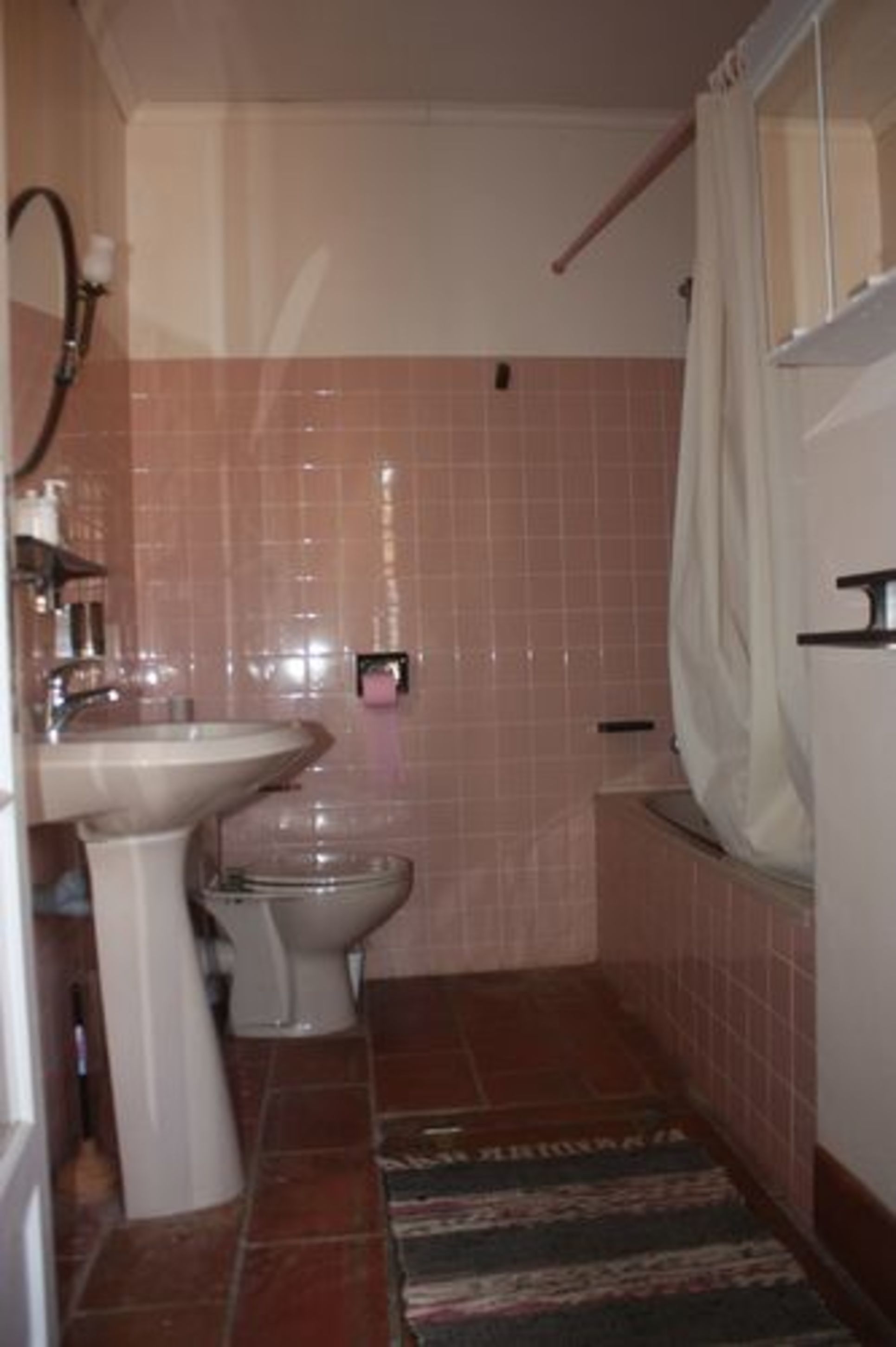 Un baño con lavabo, inodoro y cortina de ducha.