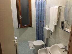 A small bathroom with a toilet, sink, and a window. - Blue Hotel Depandance (Suzzara)