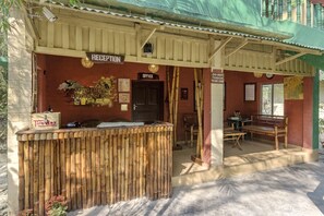 A reception area with a wooden counter, reception desk, and office. - Sunderban Tiger Camp (Gosaba)