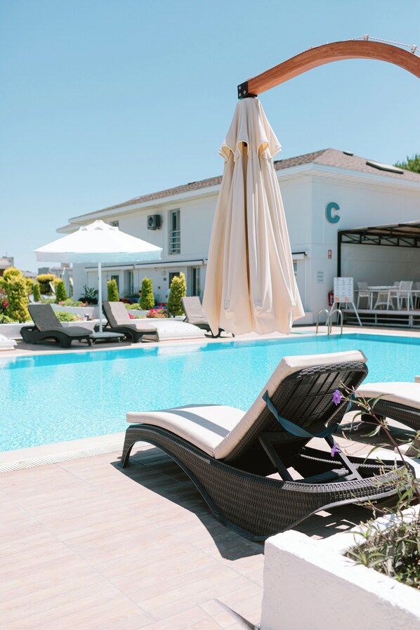 Outdoor pool, open 10:00 AM to 6:00 PM, pool umbrellas, pool loungers