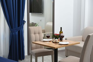 Suite, hidromasaje | Área de sala de estar | Televisión de pantalla plana de 55 pulgadas con canales por cable 