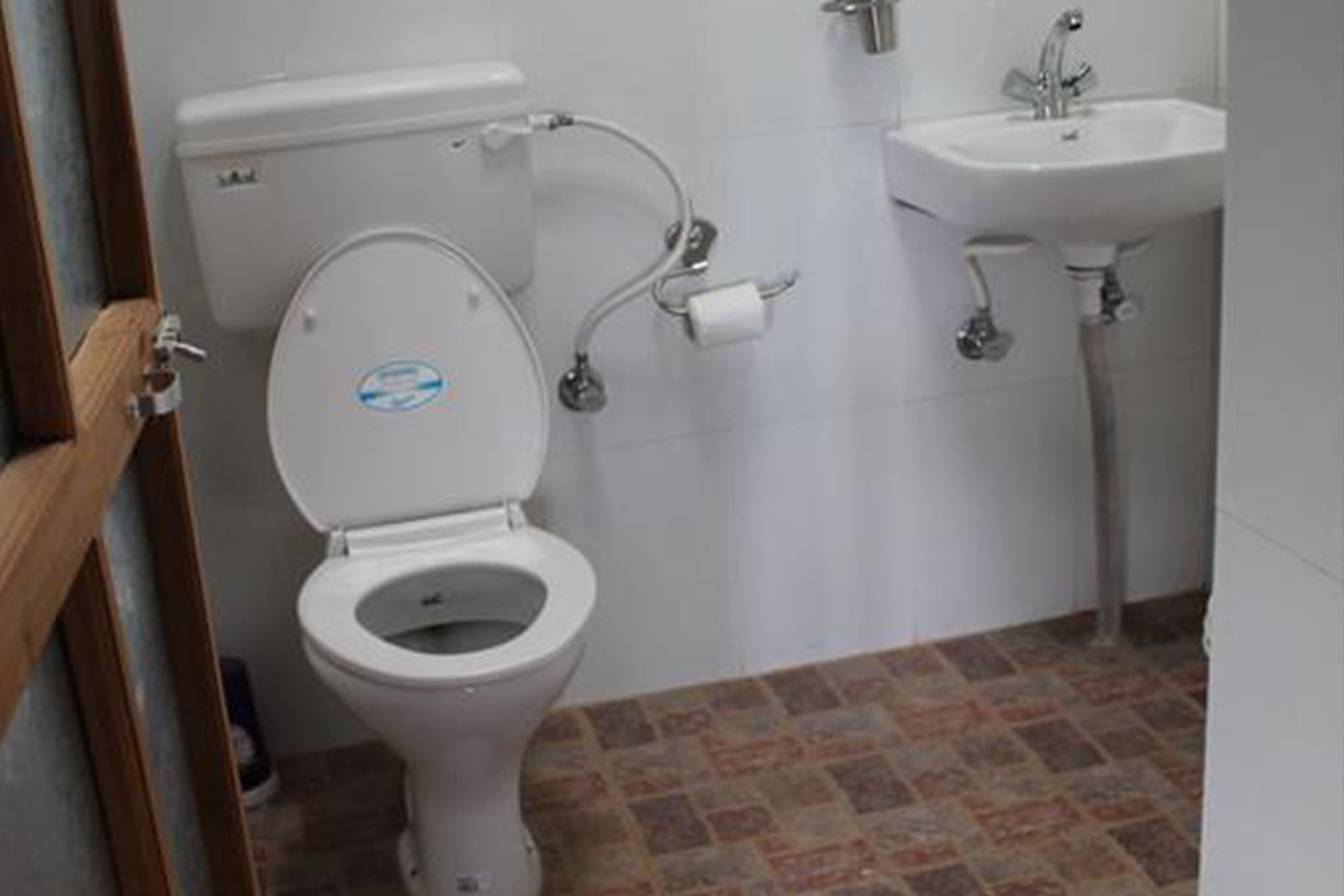 A bathroom with a toilet, a sink, and a shower.