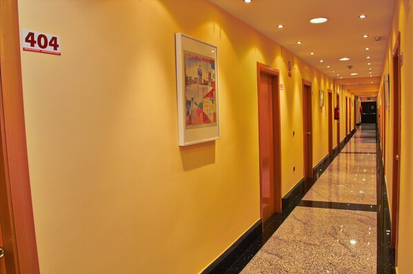 A hotel hallway with a 404 sign, doors, and a framed picture on the wall. - Residencia Universitaria Cum Laude (Salamanca)