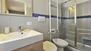 A modern bathroom with a large sink, a bidet, a glass shower enclosure, and a towel rack. - Venetian Dream in Biennale Area by Wonderful Italy (Venice)