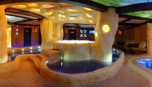 A spa area with a central water feature, stone walls, and seating areas. - Marieta Palace (Nessebar)