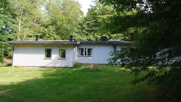 A single-story house with a gabled roof, a front door, and a small porch.